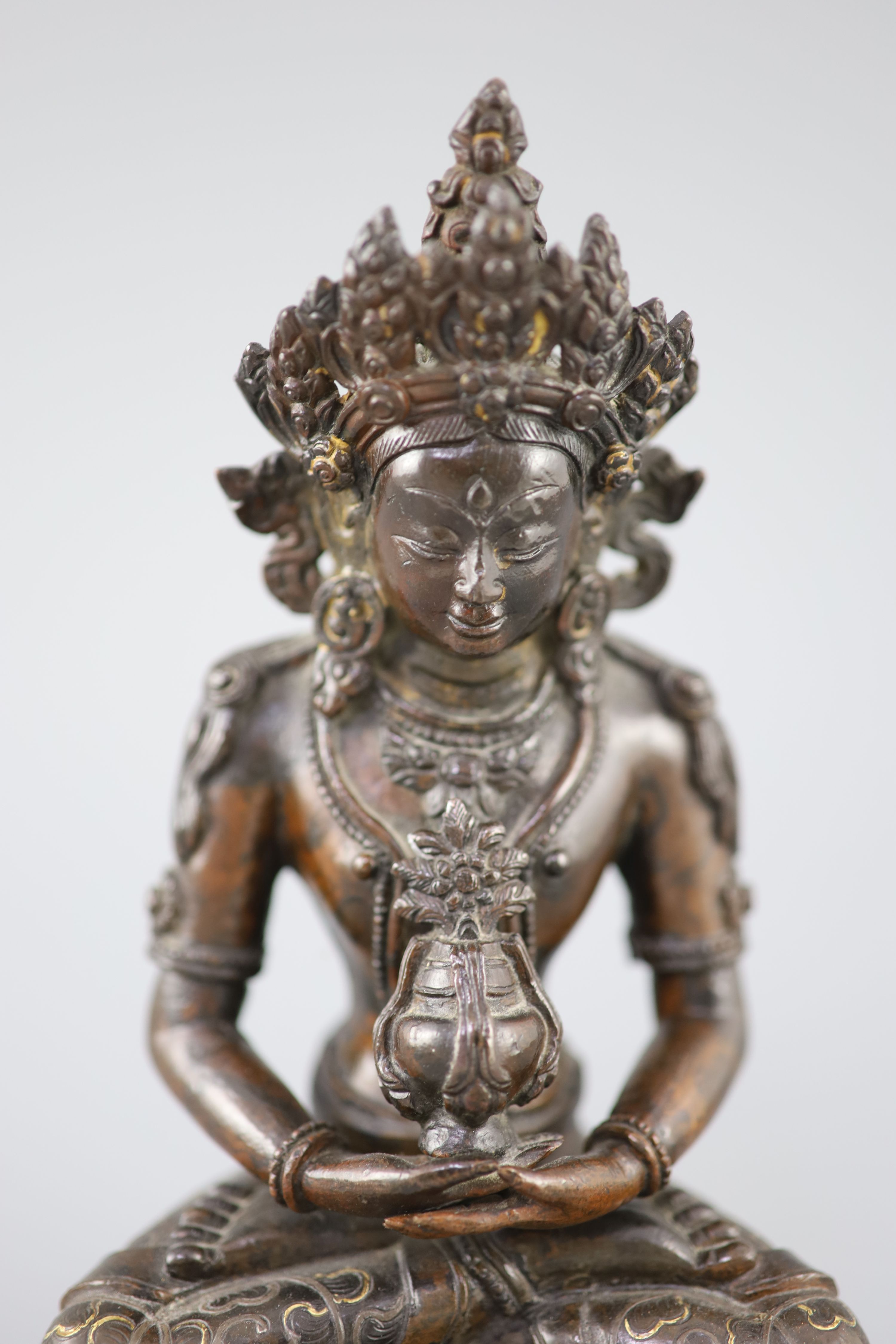 A Tibetan silver and gold inlaid copper alloy figure of Amitayus/Amitabha, c.15th century, 20.5cm high
